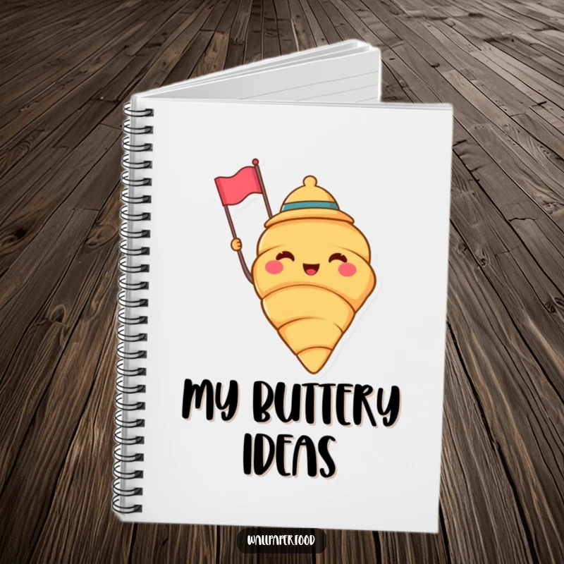 Funny notebook with a cheerful croissant wearing a jaunty hat and waving a tiny flag, perfect for taking notes with baking flair. A funny gift.